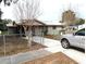 House exterior with driveway and chain link fence at 217 Bay E St, Davenport, FL 33837