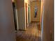 Long hallway with wood-look floors and multiple doors at 217 Bay E St, Davenport, FL 33837