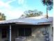 House exterior showing metal roof and back patio at 217 Bay E St, Davenport, FL 33837