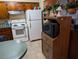 Kitchen with wood cabinets, white appliances, and microwave at 217 Bay E St, Davenport, FL 33837