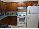 Kitchen with wood cabinets and white appliances at 217 Bay E St, Davenport, FL 33837