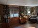 Bright living room with wood paneled walls and tiled floors at 217 Bay E St, Davenport, FL 33837