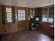 Living room with wood paneled walls, tiled floors, and a view of the backyard at 217 Bay E St, Davenport, FL 33837