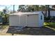 Large storage shed with metal roof and roll-up door at 217 Bay E St, Davenport, FL 33837