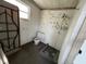 Bathroom in need of repair with vintage-patterned wall design at 3445 Avenue F Nw, Winter Haven, FL 33881