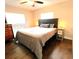 Bedroom with neutral color scheme, two windows, and hardwood floors at 3445 Avenue F Nw, Winter Haven, FL 33881