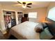 Bedroom featuring a ceiling fan, two closets, and a comfortable queen bed at 3445 Avenue F Nw, Winter Haven, FL 33881