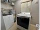 An organized laundry area featuring washer, dryer and water heater at 3445 Avenue F Nw, Winter Haven, FL 33881