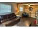 Comfortable living room featuring wood floors, leather sofa, and natural light at 3445 Avenue F Nw, Winter Haven, FL 33880