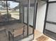 View of a screened porch with brick accent wall and seating at 3445 Avenue F Nw, Winter Haven, FL 33880