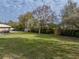 Spacious backyard with lush grass and wooden fence at 3703 White Oak Ct, Lake Wales, FL 33898