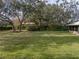 Expansive backyard with mature trees and lush grass at 3703 White Oak Ct, Lake Wales, FL 33898