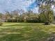 Large backyard with grass, trees, and wooden fence at 3703 White Oak Ct, Lake Wales, FL 33898