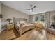 Main bedroom with light walls, wood-look floors, and a large bed at 3703 White Oak Ct, Lake Wales, FL 33898