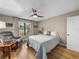 Serene bedroom with a queen-sized bed, armchair, and large window at 3703 White Oak Ct, Lake Wales, FL 33898