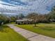 House with long driveway and mature trees at 3703 White Oak Ct, Lake Wales, FL 33898