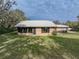 Brick house with large windows and a metal roof at 3703 White Oak Ct, Lake Wales, FL 33898