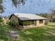 Brick house with a sunroom and a metal roof at 3703 White Oak Ct, Lake Wales, FL 33898