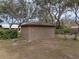 Rear view of tan colored storage shed at 3703 White Oak Ct, Lake Wales, FL 33898