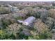 Charming home with a metal roof nestled among mature trees, offering privacy at 41 Spring Ln, Haines City, FL 33844