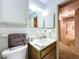 Well-lit bathroom with vanity, sink and view to hallway at 41 Spring Ln, Haines City, FL 33844