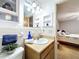 Well-lit bathroom with vanity, sink and tile backsplash, and view to bedroom at 41 Spring Ln, Haines City, FL 33844