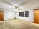 Spacious carpeted bedroom with a ceiling fan and large windows at 41 Spring Ln, Haines City, FL 33844