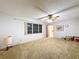 Carpeted bedroom featuring natural light, a ceiling fan, and closet space at 41 Spring Ln, Haines City, FL 33844