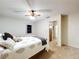 Comfortable bedroom featuring carpet flooring, ceiling fan and view into the hallway at 41 Spring Ln, Haines City, FL 33844