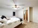 Comfortable bedroom featuring carpet flooring, ceiling fan and view into the hallway at 41 Spring Ln, Haines City, FL 33844