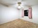 Clean bedroom featuring carpet flooring, ceiling fan and one window at 41 Spring Ln, Haines City, FL 33844