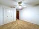 Comfortable bedroom featuring carpet flooring, ceiling fan and closet at 41 Spring Ln, Haines City, FL 33844