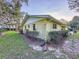 Side view of a well-maintained home featuring brick siding and neatly trimmed landscaping at 41 Spring Ln, Haines City, FL 33844