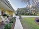 Cozy front porch featuring rocking chairs, potted plants, and a charming view of the front yard at 41 Spring Ln, Haines City, FL 33844