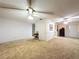 Spacious living room featuring plush carpeting, ceiling fans, and ample natural light at 41 Spring Ln, Haines City, FL 33844