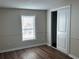 This cozy bedroom offers natural light, modern wood-look flooring, and sliding door closet at 4128 W Bella Vista St, Lakeland, FL 33810