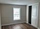 This cozy bedroom offers natural light, modern wood-look flooring, and sliding door closet at 4128 W Bella Vista St, Lakeland, FL 33810