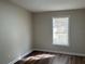 Inviting bedroom with laminate flooring, a neutral color scheme, and natural light from the window at 4128 W Bella Vista St, Lakeland, FL 33810