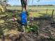 Backyard well system with blue holding tank and plumbing, adjacent to fenced areas at 4128 W Bella Vista St, Lakeland, FL 33810