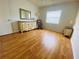 Bright bedroom with beautiful hardwood floors and a dresser at 419 Broward Ter, Winter Haven, FL 33884