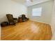 Comfortable bedroom with hardwood floors, window, and stylish chairs at 419 Broward Ter, Winter Haven, FL 33884