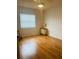 Well-lit bedroom featuring hardwood floors, a window, and neutral walls at 419 Broward Ter, Winter Haven, FL 33884