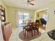 Cozy dining room with tile floors, neutral colors, and natural light, located near the sliding door to the pool at 419 Broward Ter, Winter Haven, FL 33884