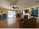 Bright living room with fireplace, built-in shelving, hardwood floors, and sliding doors that overlook the pool at 419 Broward Ter, Winter Haven, FL 33884