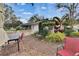 Outdoor living space with a brick patio, dining set, and well-manicured landscaping, perfect for entertaining at 4523 Hallamview Ln, Lakeland, FL 33813