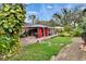 Serene backyard with brick patio, pergola, lush greenery, and space for outdoor entertaining at 4523 Hallamview Ln, Lakeland, FL 33813