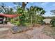 Lush backyard featuring brick paving, rock beds, mature trees, and ambient string lights at 4523 Hallamview Ln, Lakeland, FL 33813