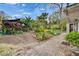 Lush backyard oasis with brick pavers, mature trees, and colorful plants, creating a tranquil outdoor retreat at 4523 Hallamview Ln, Lakeland, FL 33813