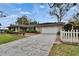 Charming single-Gathering home with an attached garage, manicured lawn, and inviting curb appeal at 4523 Hallamview Ln, Lakeland, FL 33813