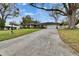 Well-kept single-story home featuring a spacious driveway and mature landscaping at 4523 Hallamview Ln, Lakeland, FL 33813